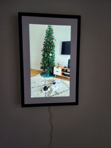 Photo of digital art display with image of dog and Christmas tree