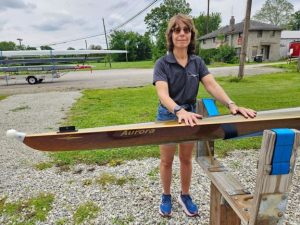 Photo of Meg with new single scull named Aurora.